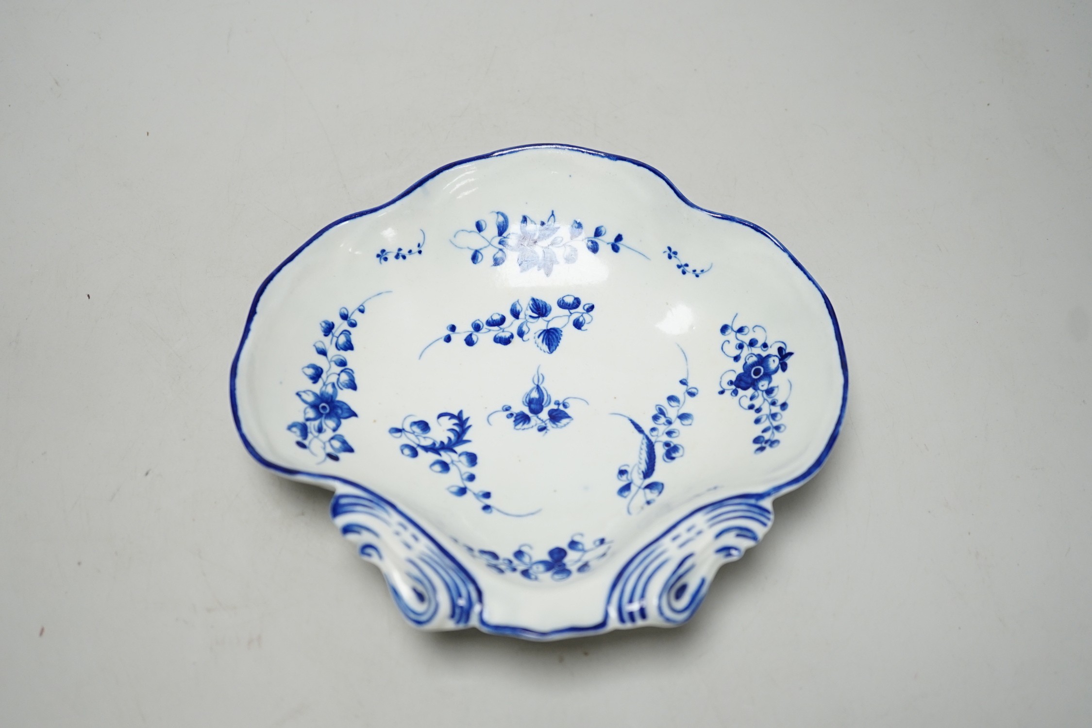 An 18th century Caughley shell dish painted with Bright, Sprigs, impressed Salopian, 19.5cm wide